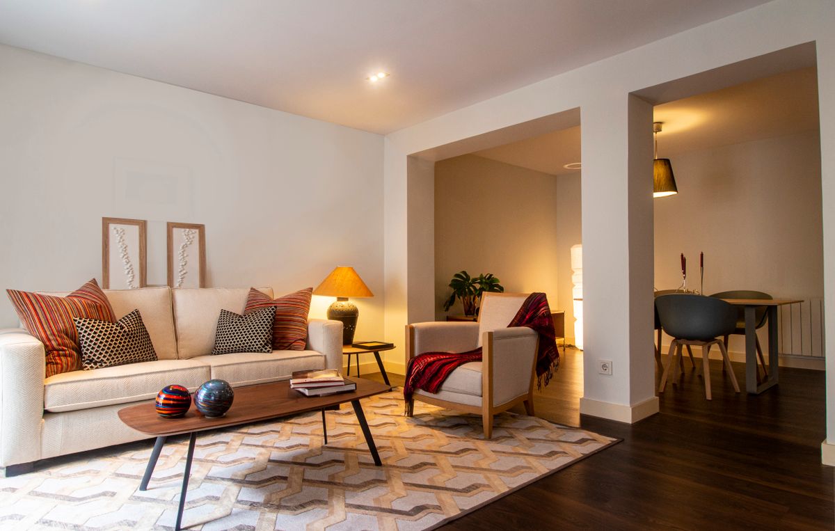 Illustrative sunlit living room with neutral furnishings; not a photo of Timberline Apartments